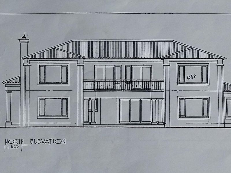 Architectural drawing showing the north elevation of a two-story residential property with a balcony and symmetrical window layout.