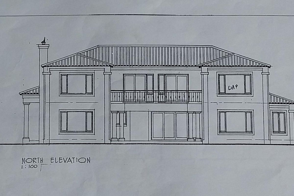 Architectural drawing showing the north elevation of a two-story residential property with a balcony and symmetrical window layout.
