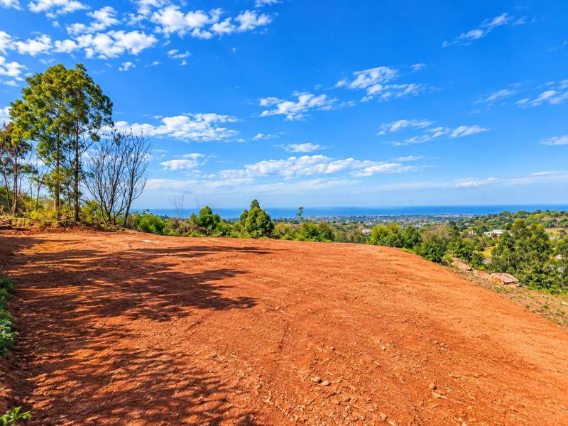 A vacant residential plot featuring elevated terrain and expansive coastal views, offering a prime opportunity for custom development.