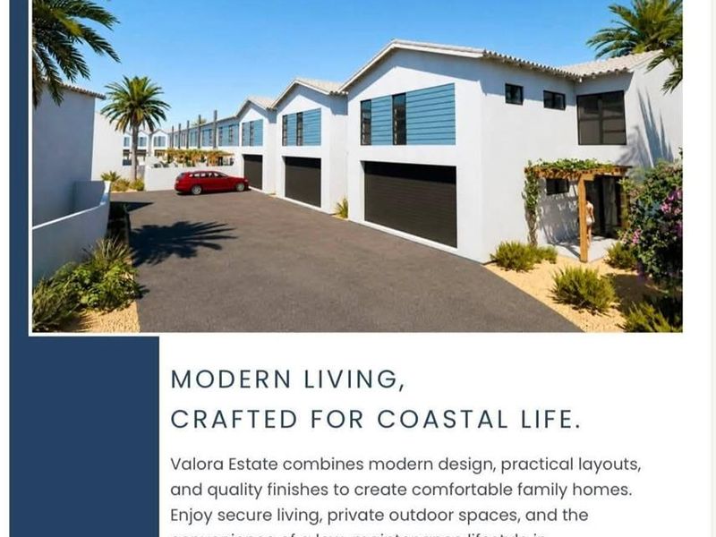 Modern townhouse exterior featuring a double garage, paved driveway, and contemporary architectural design in a coastal estate setting.