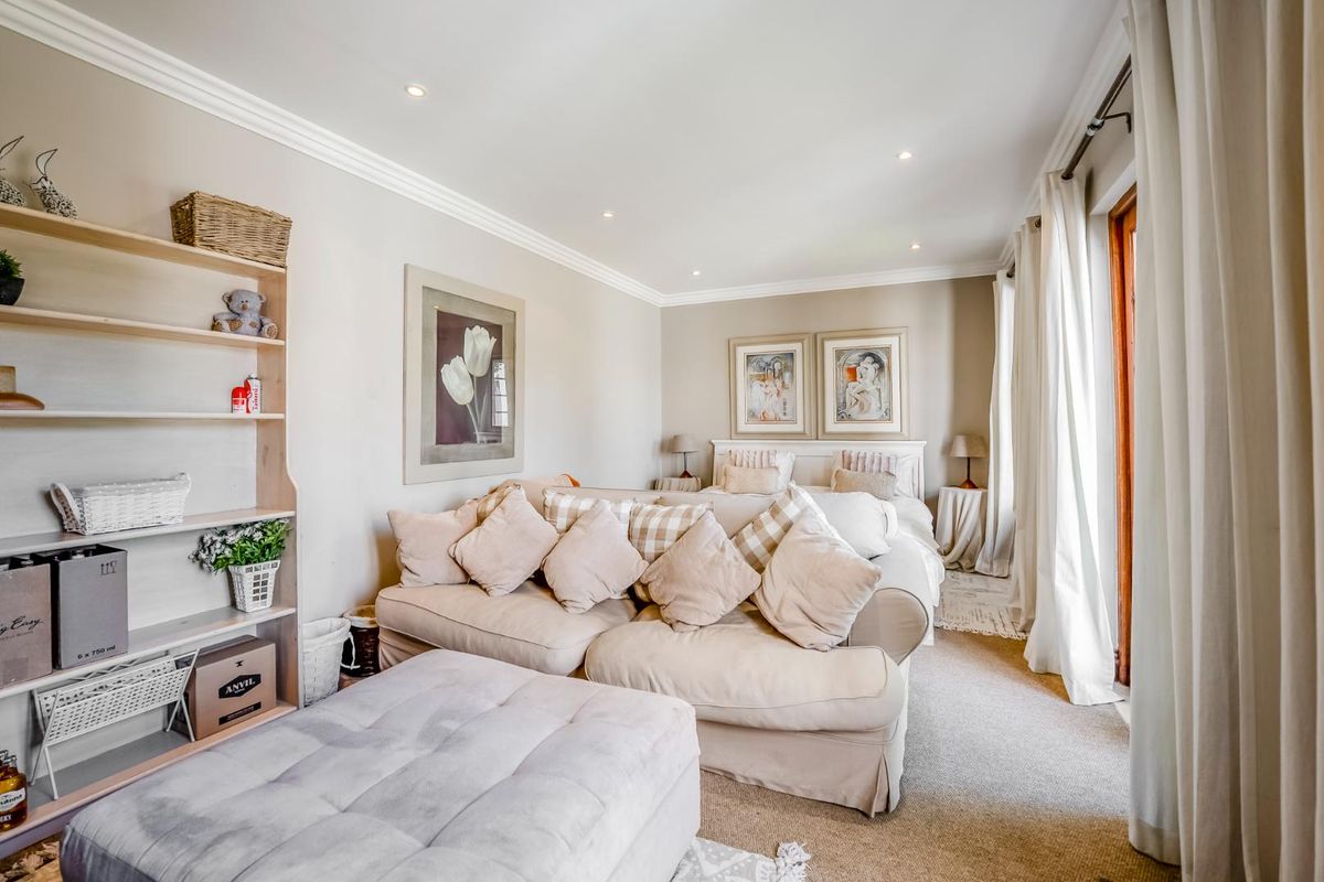 A well-maintained bedroom featuring crown molding, recessed lighting, built-in shelving, and direct access to an outdoor area through sliding glass doors.