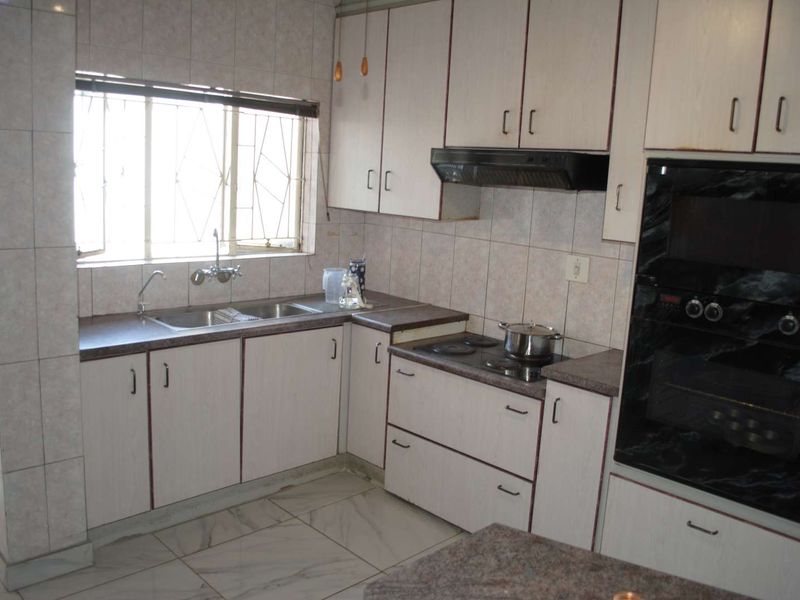 Renovated, built up, and expanded into a neat four-bedroom home with multiple living rooms and Bar area - Photo 10