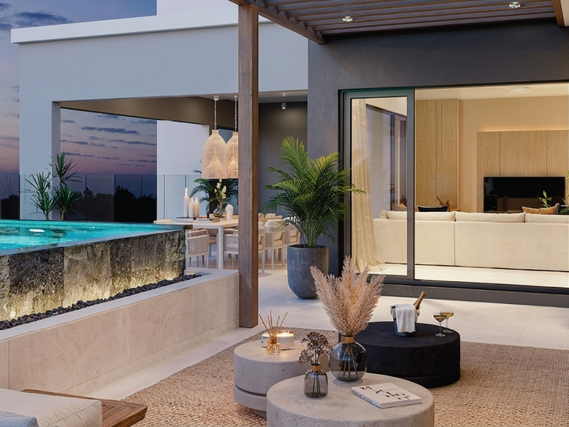 Luxury penthouse balcony featuring an infinity edge pool, glass balustrades, timber pergola, and seamless indoor-outdoor flow through large sliding glass doors.
