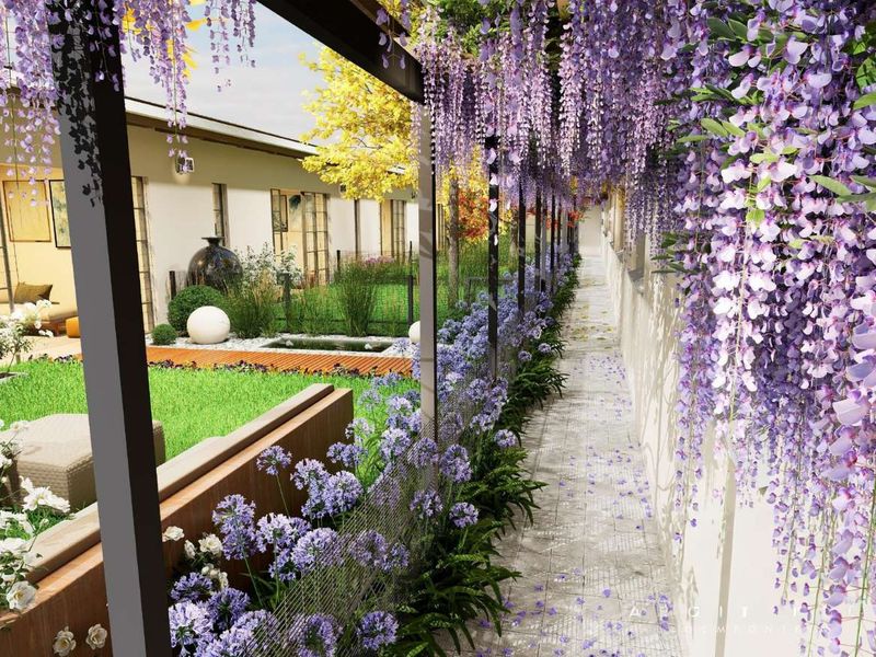 A beautifully landscaped garden featuring a wisteria-covered pergola, a paved walkway, and a serene water feature, creating an inviting outdoor space.