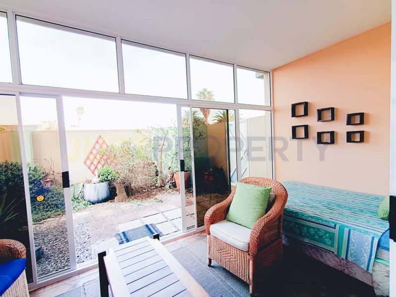 Enclosed patio area featuring large sliding glass doors providing natural light and direct access to the rear garden space.
