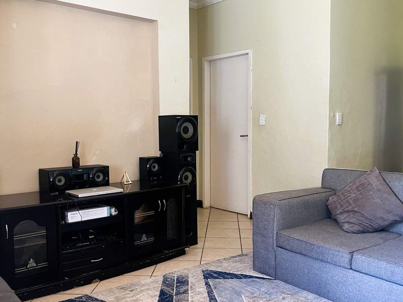 A living room featuring tiled flooring and neutral wall finishes, providing a functional space for relaxation.