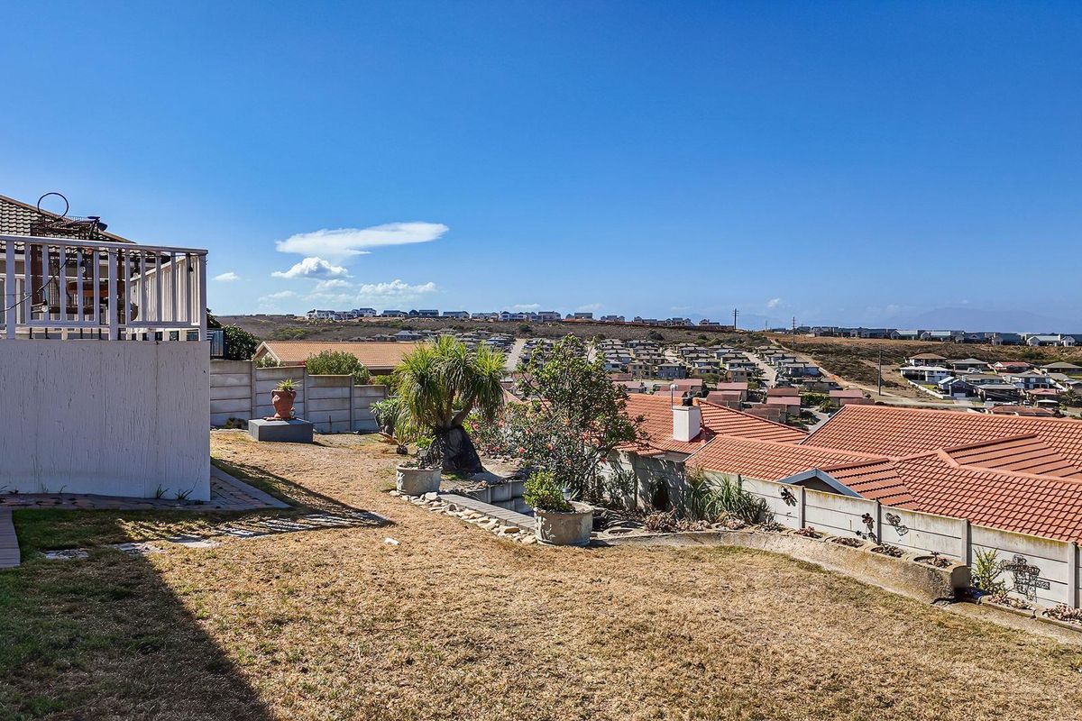 A rear garden area featuring a raised patio deck and expansive views over the surrounding residential neighborhood.