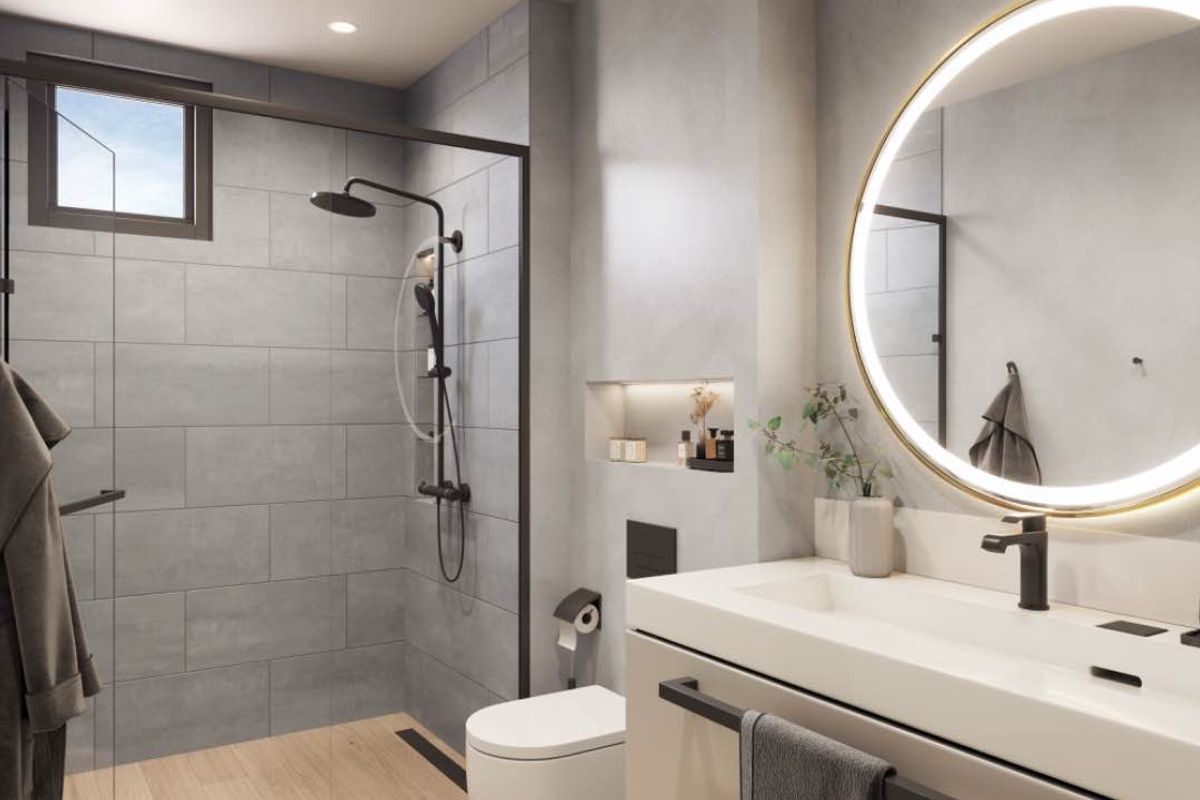 Modern bathroom featuring a walk-in shower with matte black fixtures, a wall-mounted toilet, and a sleek vanity with an illuminated circular mirror.