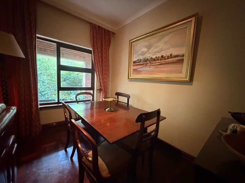 A cozy dining room featuring timber-framed windows, coving, and traditional skirting boards, offering a warm and classic atmosphere.