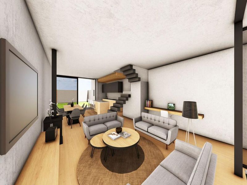 Modern open-plan living area featuring a contemporary kitchen, integrated staircase, and large sliding glass doors leading to the outdoor space.
