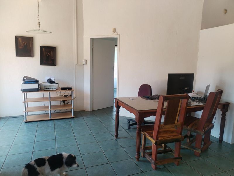 A functional office space featuring tiled flooring and a neutral wall finish, suitable for a home workspace or study area.