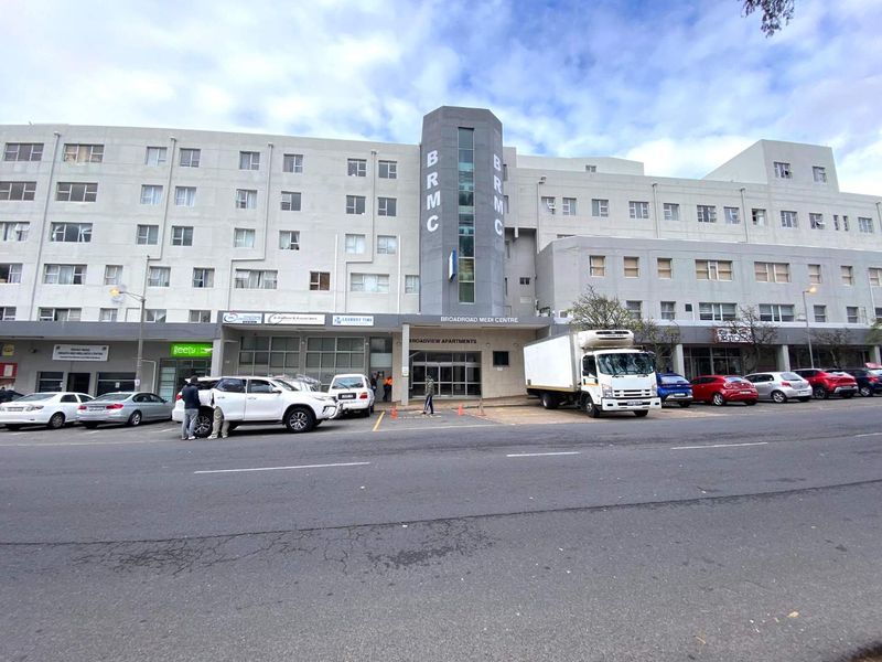 Front exterior view of the Broadview Apartments building, featuring a multi-story facade with ground-level commercial units and street-level access.