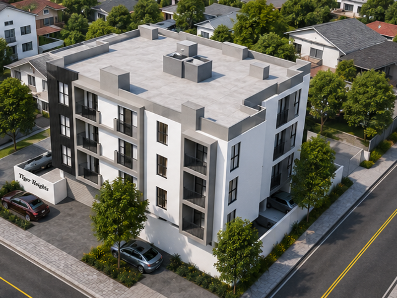 Aerial view of Tiger Heights apartment complex featuring a modern multi-story building with balconies, flat roof, and paved parking area.