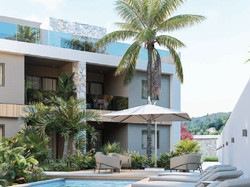 A modern penthouse pool area featuring timber decking, glass balustrades, and stone-clad architectural elements, creating a luxurious outdoor living space.