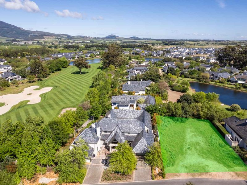 Aerial view of a vacant residential plot situated within a prestigious golf estate, offering scenic views and established surroundings.