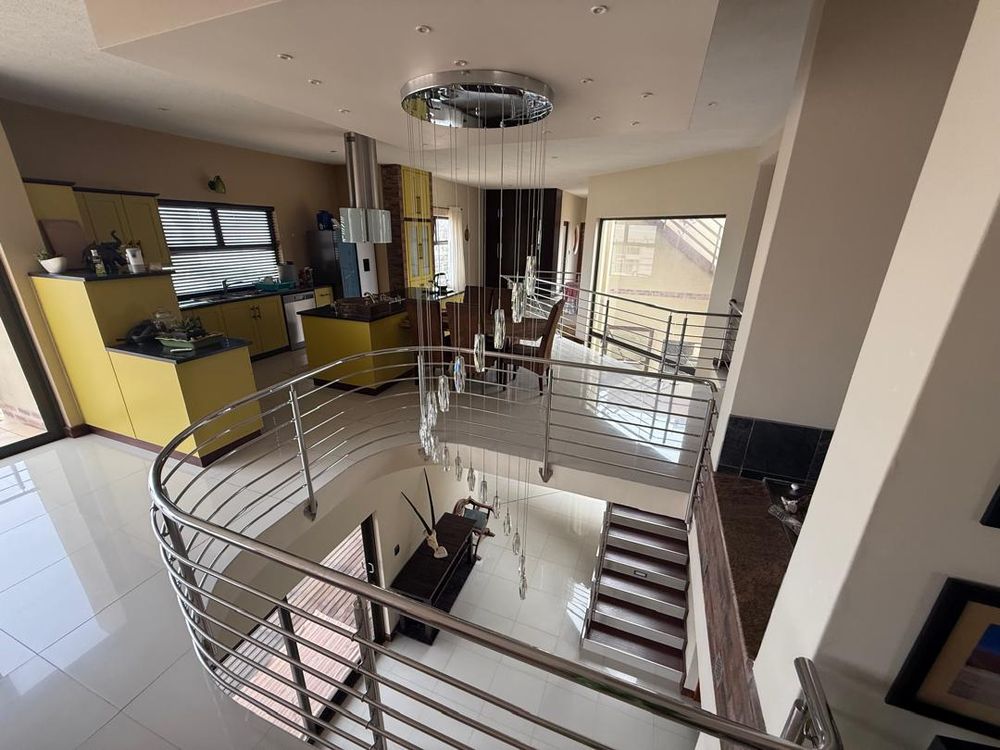Kitchen with BIC, oven and stove. Decorative balcony viewing to the ground floor