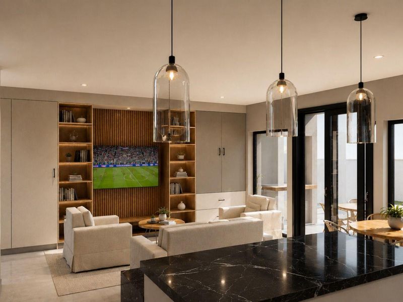 Modern open-plan living area featuring a sleek black marble kitchen island, custom built-in cabinetry, slatted timber feature wall, and seamless access to the patio.