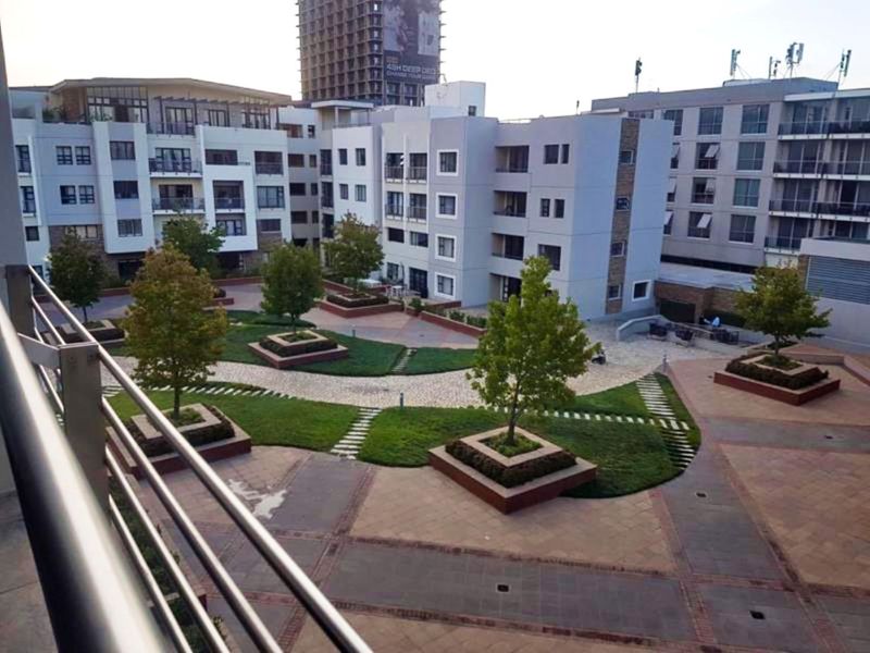 Elevated view overlooking the landscaped central courtyard and garden area of the apartment complex.