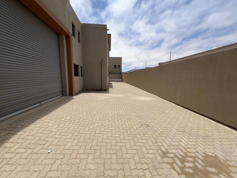 Side entrance 1 and sliding roller door leading to main dwelling 