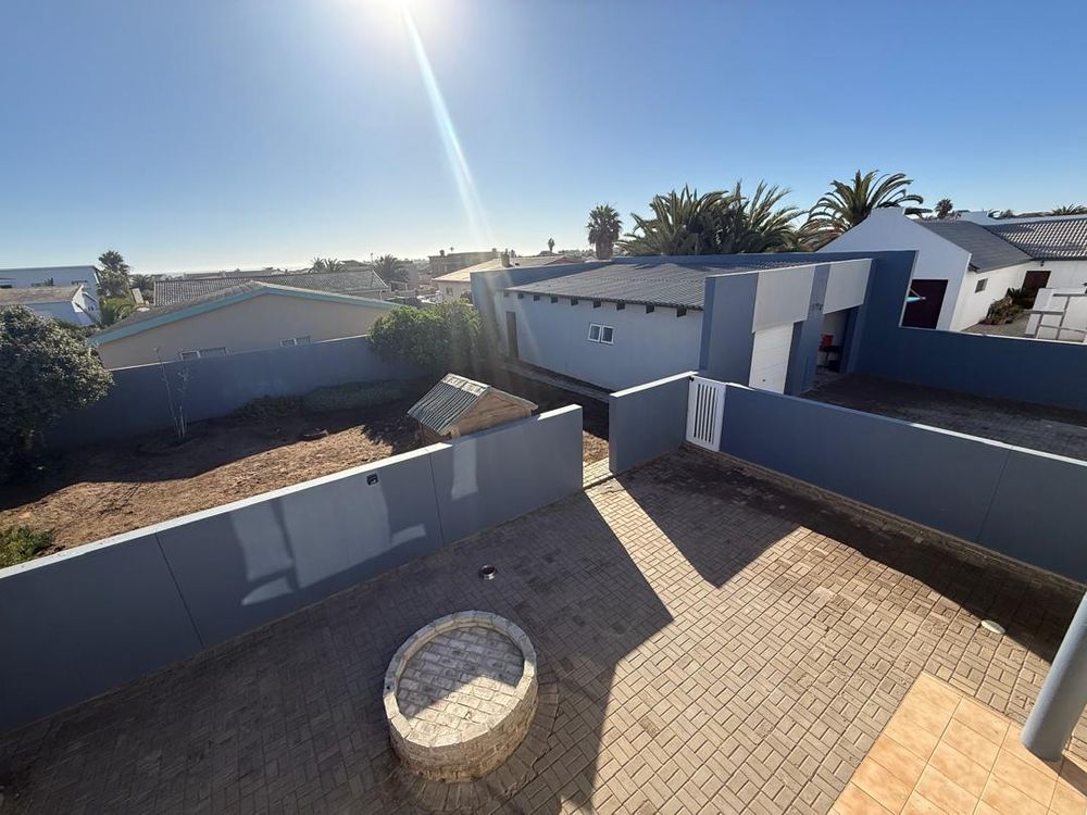 Balcony looking over the backyard. Open area for more rooms to be built. Boma for outdoor BBQ and garage