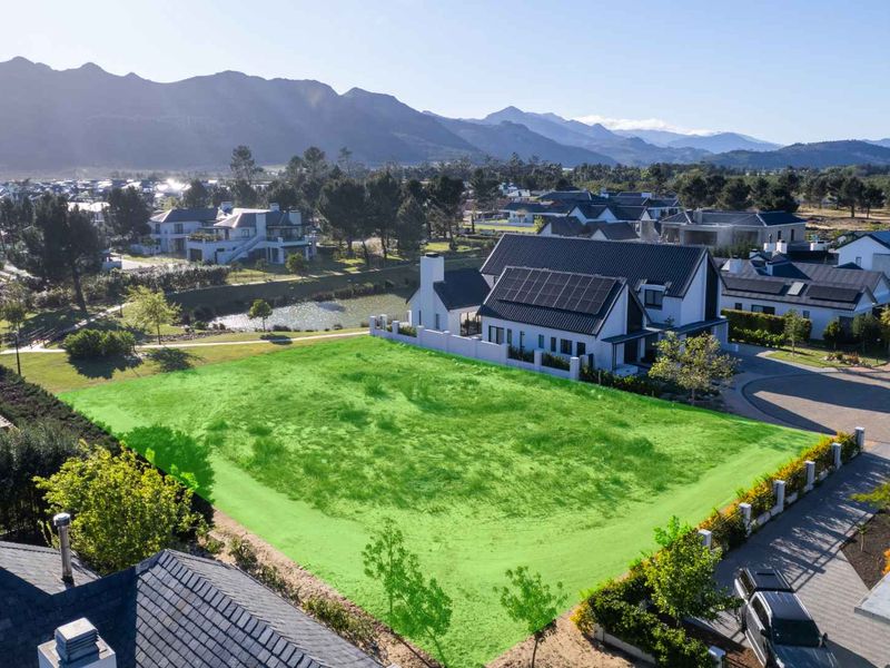Aerial view of a vacant residential land plot in a developed estate, highlighting the available building space and surrounding neighborhood context.