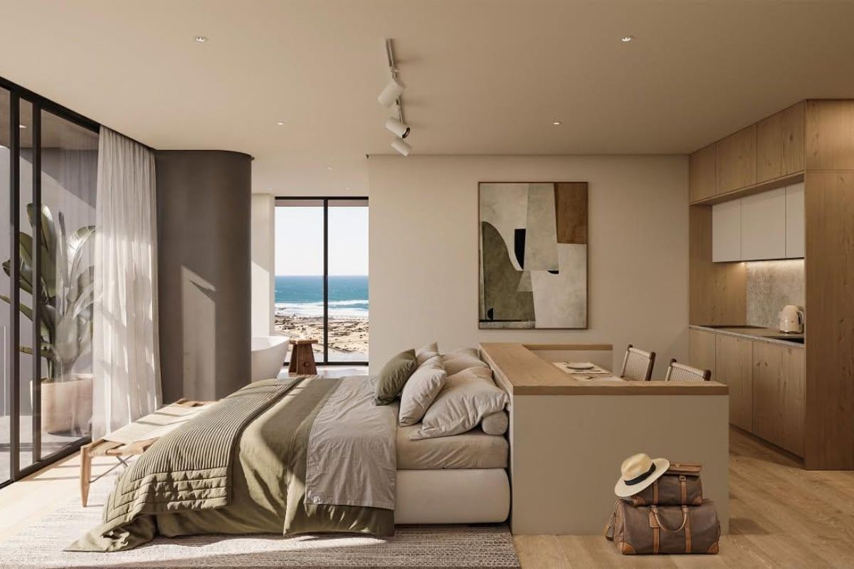 Modern penthouse bedroom featuring integrated cabinetry, hardwood flooring, and floor-to-ceiling sliding doors opening to a private balcony with ocean views.