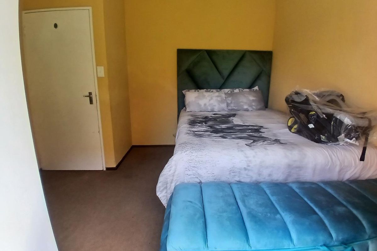 A bedroom featuring carpeted flooring and neutral wall finishes, providing a functional space for rest.