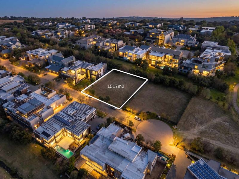 An aerial view of a 1517m2 vacant residential plot situated within a developed estate, highlighting the prime location and surrounding luxury homes.