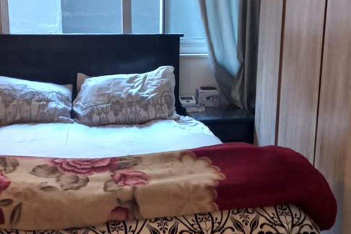 A bedroom featuring large sliding glass doors that provide natural light and access to the exterior.