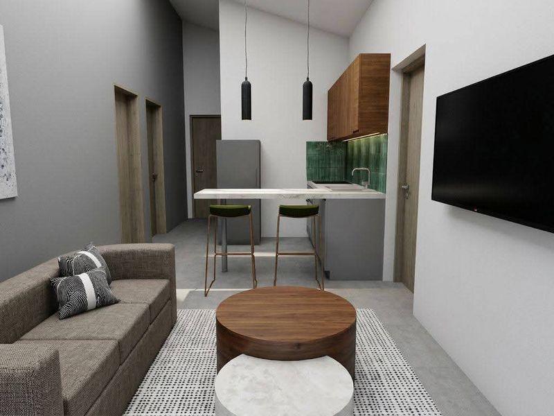 Modern open-plan living area featuring a compact kitchen with stone countertops, tiled backsplash, and sleek cabinetry, seamlessly integrated with the lounge space.