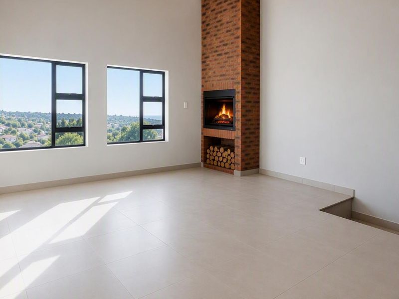 Spacious living room featuring a prominent brick fireplace, large windows with scenic views, and modern tiled flooring in a clean, open-plan layout.