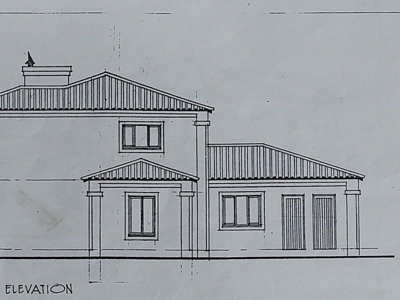 Architectural west elevation drawing showing the proposed building facade, roof structure, and window placement for the residential property.