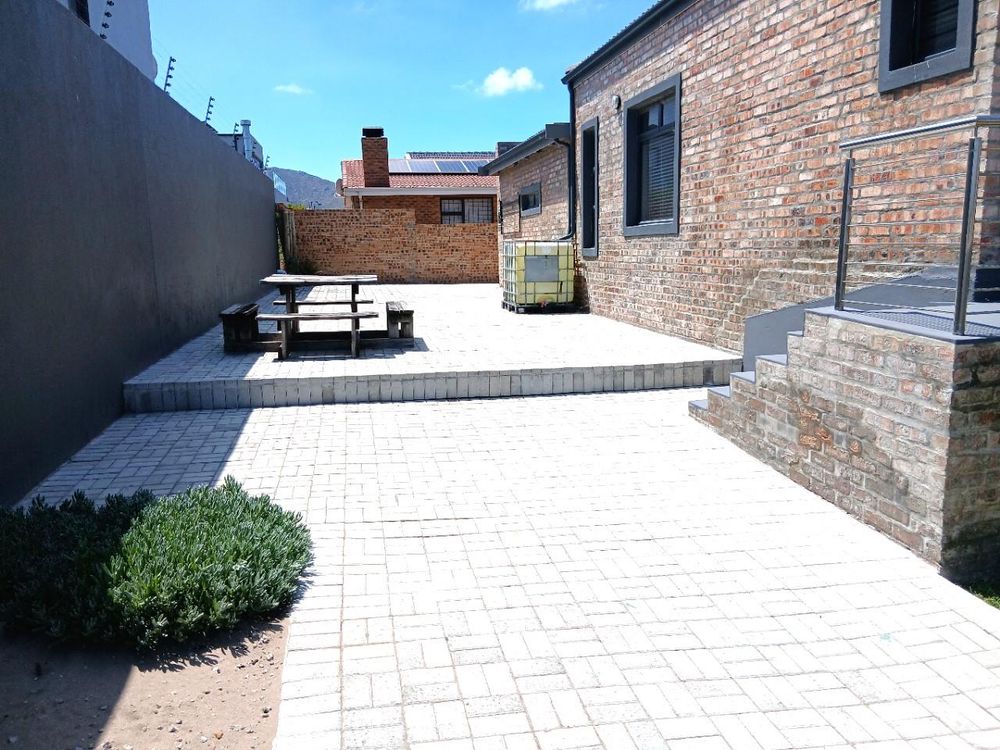 Our paved Backyard - with steps (on our right) leading to Balcony of Main Bedroom).
