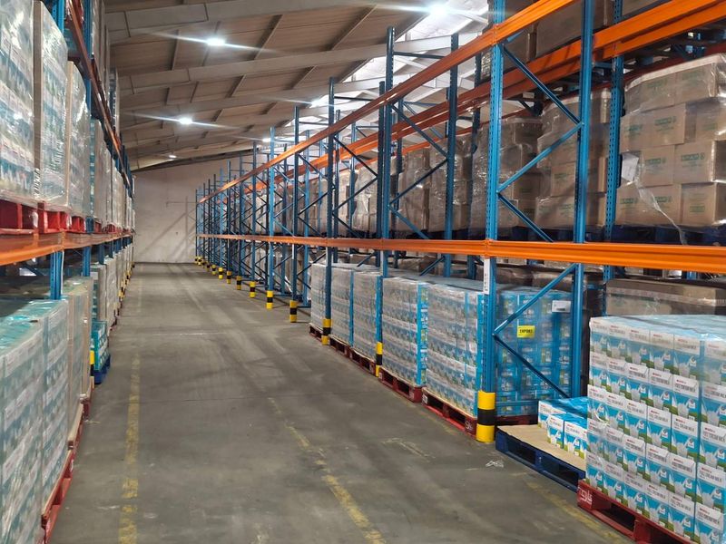 Spacious industrial warehouse featuring high-capacity steel pallet racking, durable concrete flooring, and efficient overhead LED lighting, optimized for large-scale storage and logistics operations.