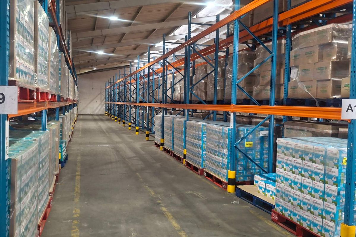 Spacious industrial warehouse featuring high-capacity steel pallet racking, durable concrete flooring, and efficient overhead LED lighting, optimized for large-scale storage and logistics operations.