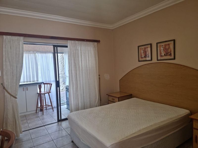 Bedroom featuring tiled flooring and a sliding glass door providing access to an outdoor patio area.