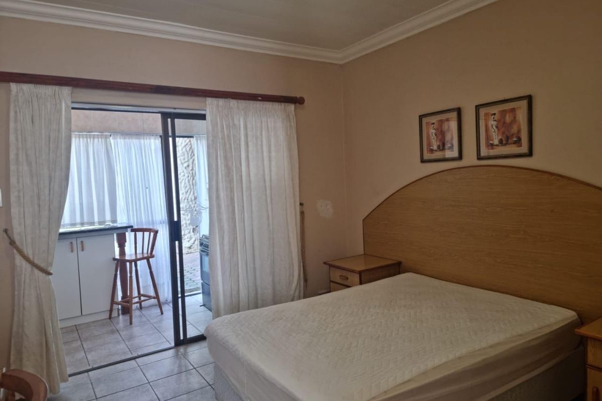 Bedroom featuring tiled flooring and a sliding glass door providing access to an outdoor patio area.