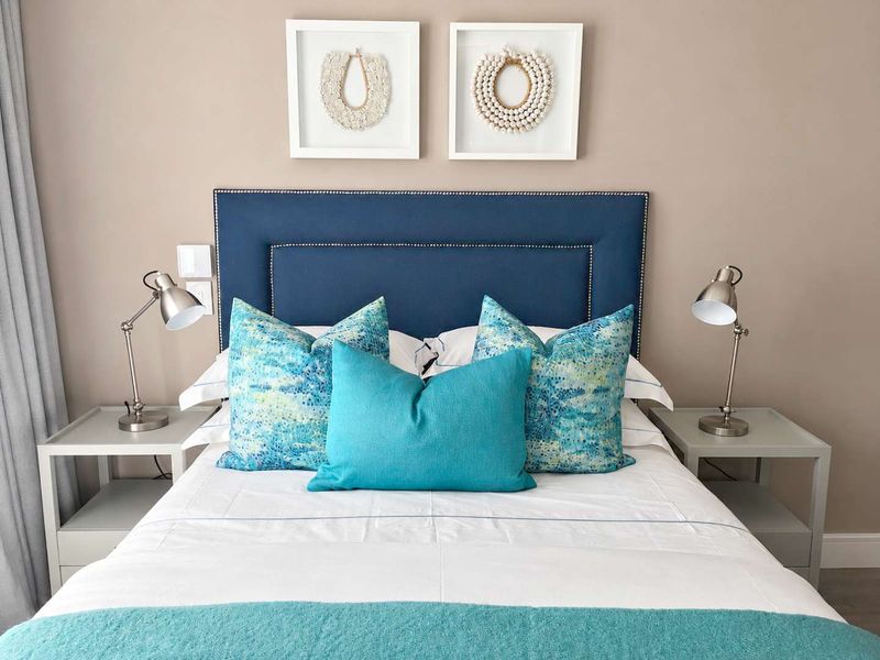 A well-maintained bedroom featuring neutral wall tones and integrated electrical fixtures, presented in a clean and tidy condition.