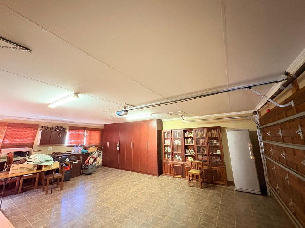 Double garage with built in cupboards.