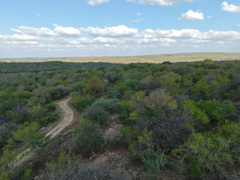 An aerial view of the vacant residential land featuring native bushveld vegetation and a dirt access track.