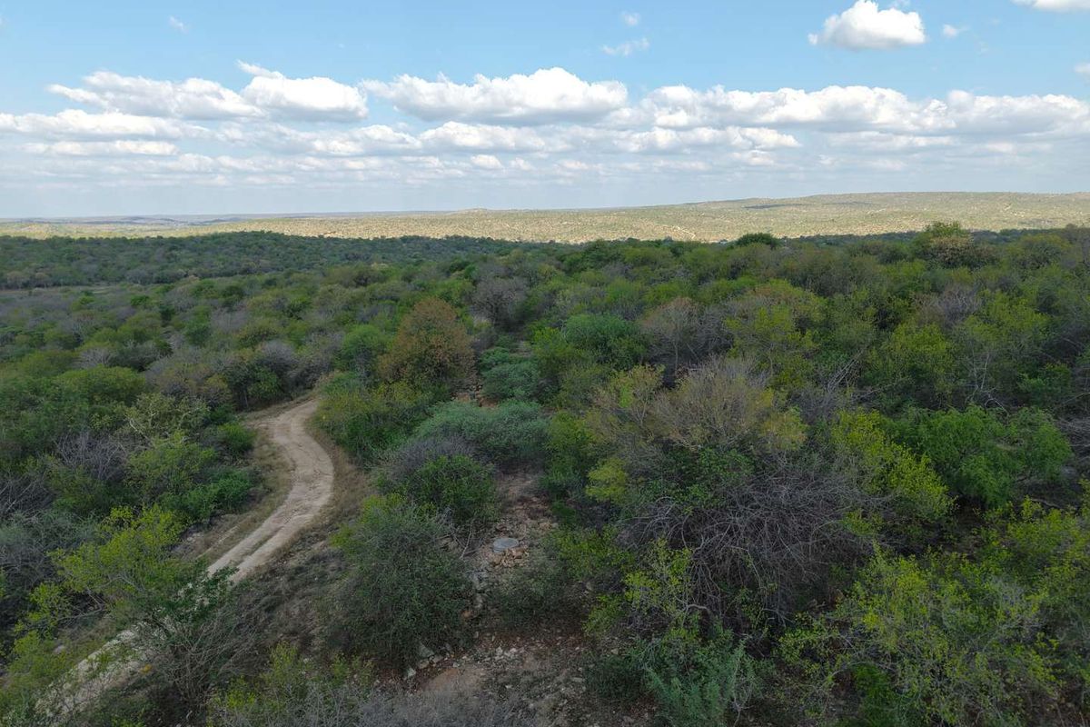 An aerial view of the vacant residential land featuring native bushveld vegetation and a dirt access track.