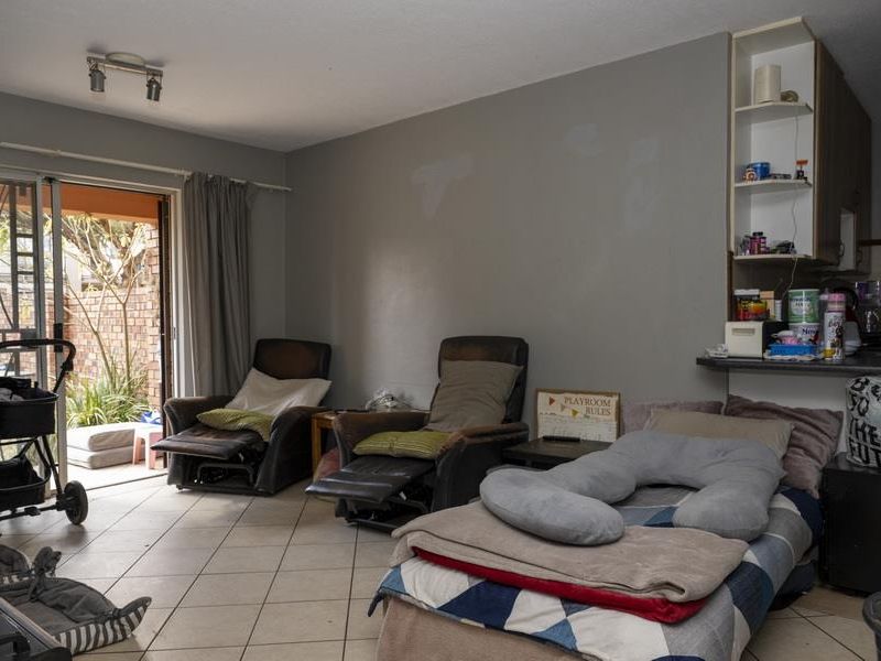 Open plan living area featuring tiled flooring and sliding glass doors leading to an outdoor patio space.
