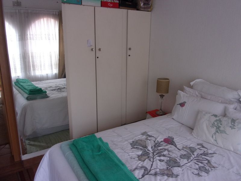 A bedroom featuring a built-in wardrobe and natural light from the window.