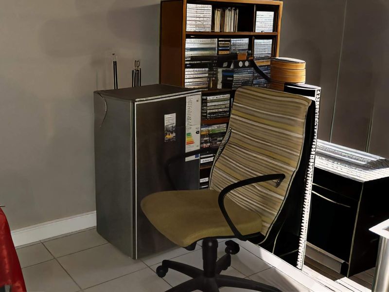 A functional office space featuring tiled flooring and neutral wall finishes, suitable for a home workspace or study area.