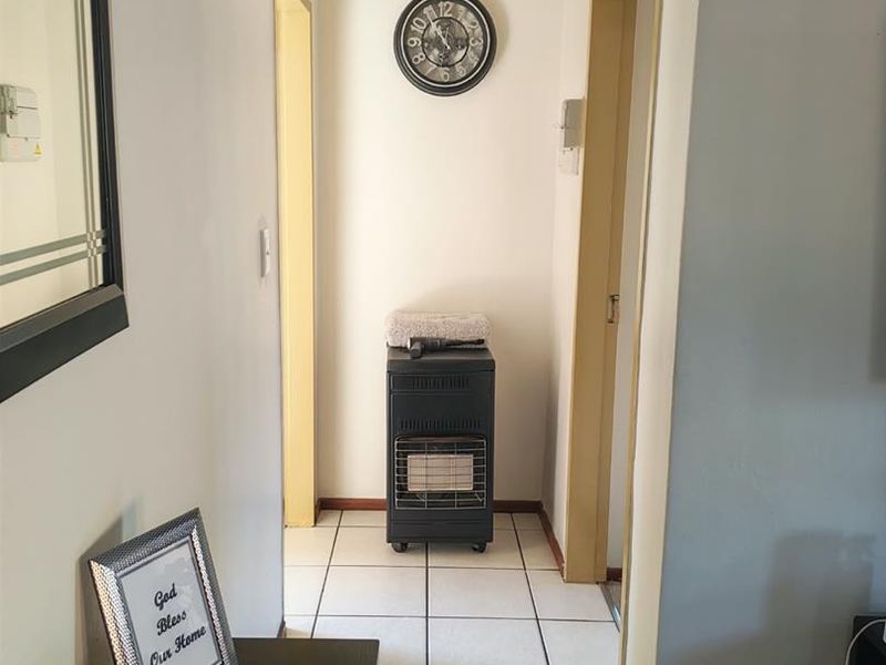 A functional hallway featuring tiled flooring and access to adjacent rooms, providing a clean and simple transition space within the townhouse.