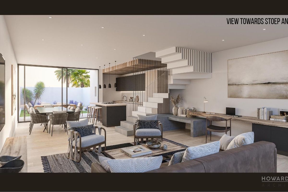 Modern open-plan living area featuring a sleek kitchen, integrated staircase, and seamless flow to the outdoor patio and garden through large sliding glass doors.