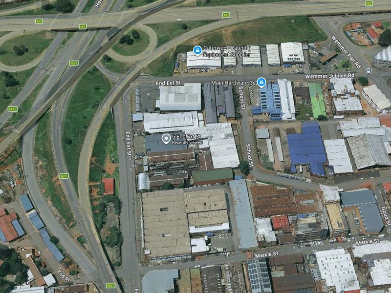 An aerial view of an industrial precinct showing multiple warehouse facilities, surrounding road infrastructure, and proximity to major highway interchanges.