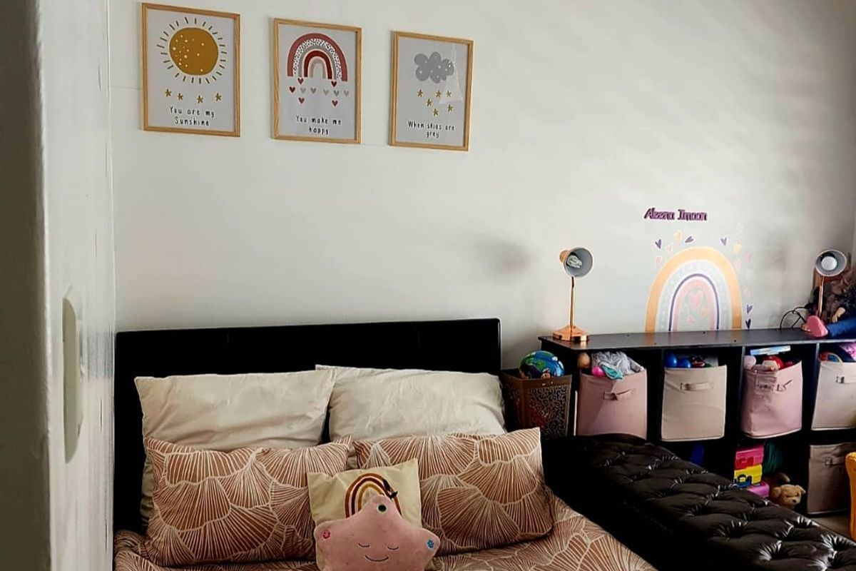 A bedroom featuring neutral wall finishes and standard lighting, suitable for a child's room or guest space.