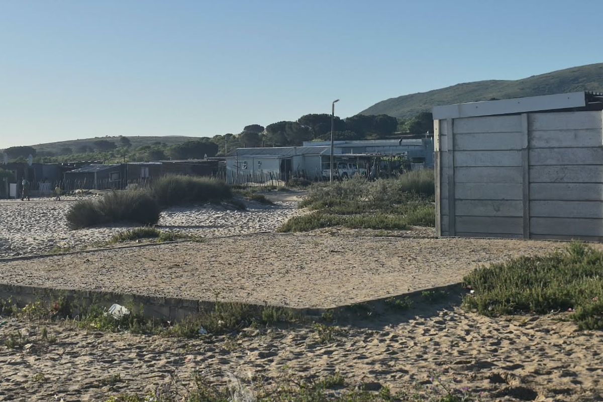 Vacant residential land featuring a concrete slab foundation and a precast concrete boundary wall, situated in a developing coastal area.