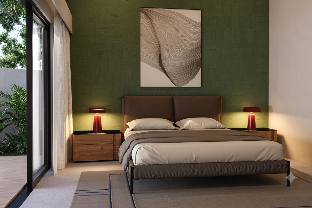 A modern bedroom featuring a textured green accent wall and large sliding glass doors providing direct access to an outdoor patio area.